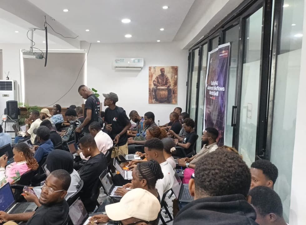 Facilitators walking between rows of attendees working on laptops at Antitect's first workshop in Lagos.
